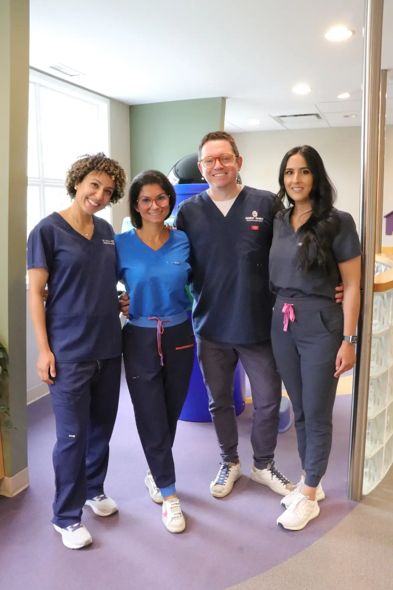 Four Chew Chew team members standing together in the waiting area